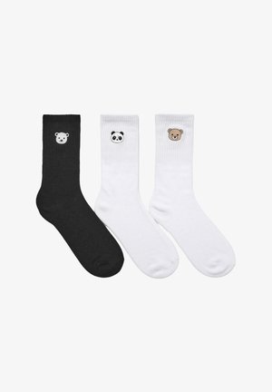 Tre paia di calze di cotone: un paio nero con un orso polare, e due paia bianchi con design di panda e orso bruno. Texture morbida, polsini a coste.