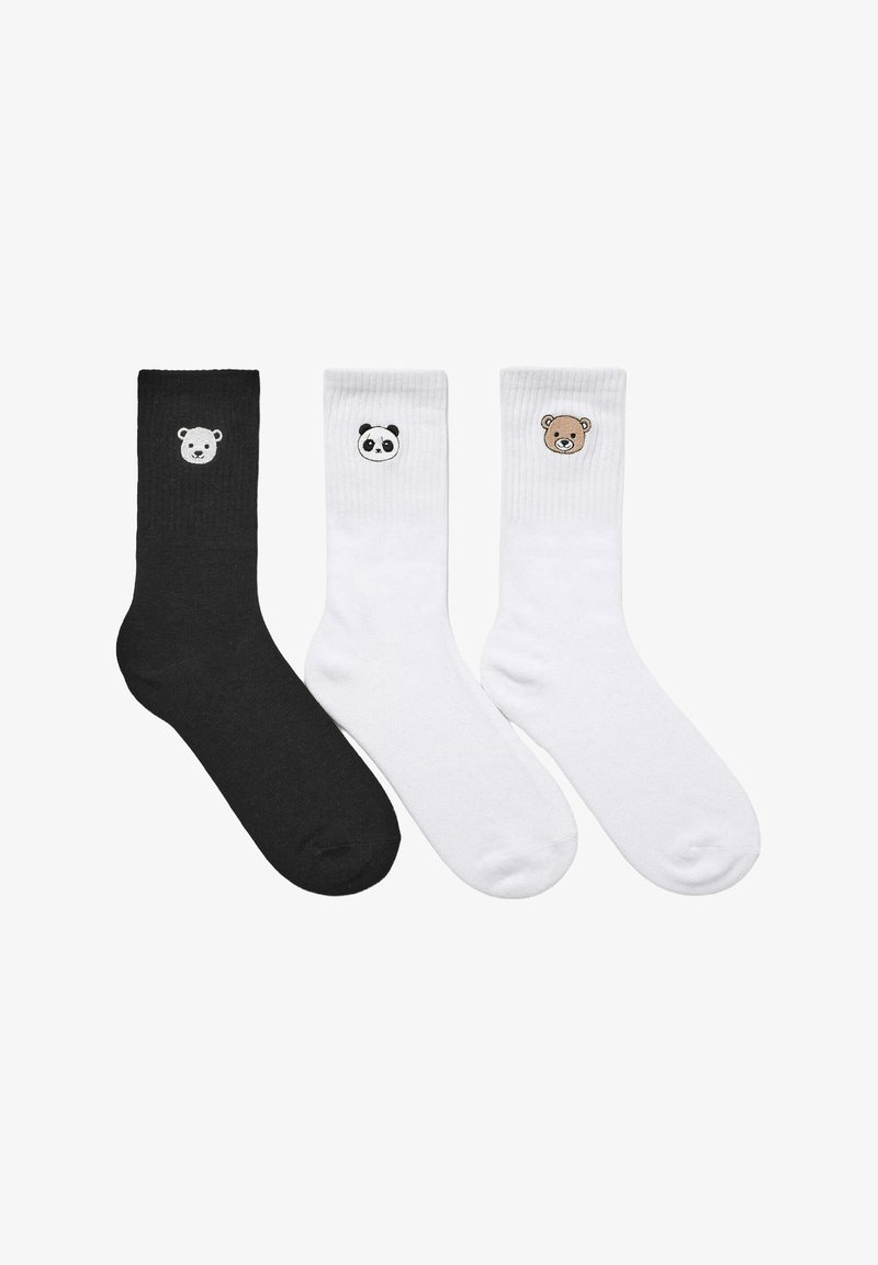 Trzy pary bawełnianych skarpetek: jedna czarna z polarnym niedźwiedziem oraz dwie białe z wzorami pandy i brunatnego niedźwiedzia. Miękka tekstura, ścianki ribbed.