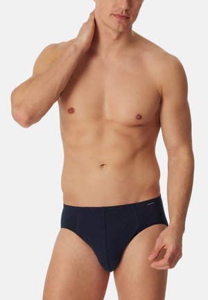Dunkelblaue Baumwollslips mit glatter Textur, ausgestattet mit einem schmalen Bund und minimaler Naht. Entworfen für eine enge Passform und hohen Komfort.