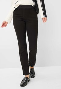 Schwarze, eng anliegende Hosen mit glatter Textur und einem hohen, elastischen Bund, ausgestattet mit Vorderentaschen und einem geraden Bein.