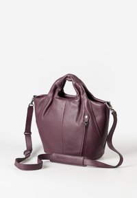 Borsa a mano in pelle viola con manici corti, una tracolla removibile e regolabile, e una piccola tasca con zip esterna su sfondo bianco.