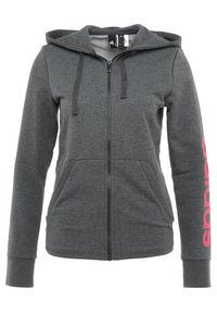 Grijze zip-up hoodie met een capuchon, voorzakken, lange mouwen en een roze grafische logo langs de rechtermouw. Gemaakt van zachte stof.