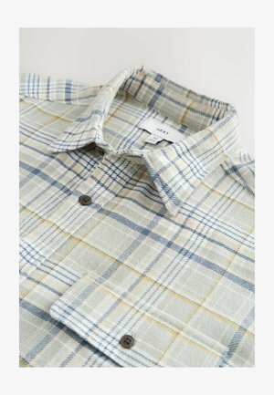 Chemise à carreaux dans des nuances de vert, bleu et jaune. Tissu doux, col boutonné et poche poitrine. Boutons marron avec une texture tissée.