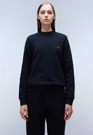 Zwart sweatshirt gemaakt van een zachte stof met een ronde hals, lange mouwen en een klein logo op de borst. Bevat ribgebreide manchetten en een onderrand.