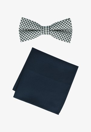 Black and white patterned bow tie above a folded dark navy blue pocket square on a white background.