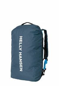 Sac à dos en nylon bleu avec un grand logo blanc, des bretelles noires réglables et une boucle latérale. Texture lisse avec une forme arrondie et compacte.