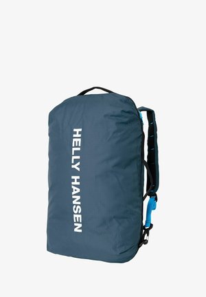 Sac à dos en nylon bleu avec un grand logo blanc, des bretelles noires réglables et une boucle latérale. Texture lisse avec une forme arrondie et compacte.