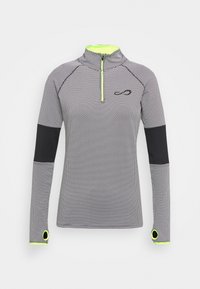 Sportovní triko s dlouhým rukávem v černozlatém puntíkovaném vzoru, má vysoký límec, poloviční zip a neonové prvky na manžetách a zipu.