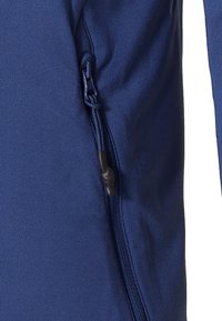 Navy blue jacket detail featuring a smooth texture, sturdy zipper with pull tab, and elastic drawstring at the hem for adjustability.