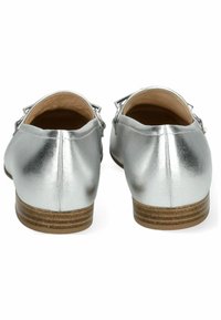 Scarpe piatte metalliche argento con tacco in legno basso, caratterizzate da una texture liscia e un semplice dettaglio con fibbia sul retro.