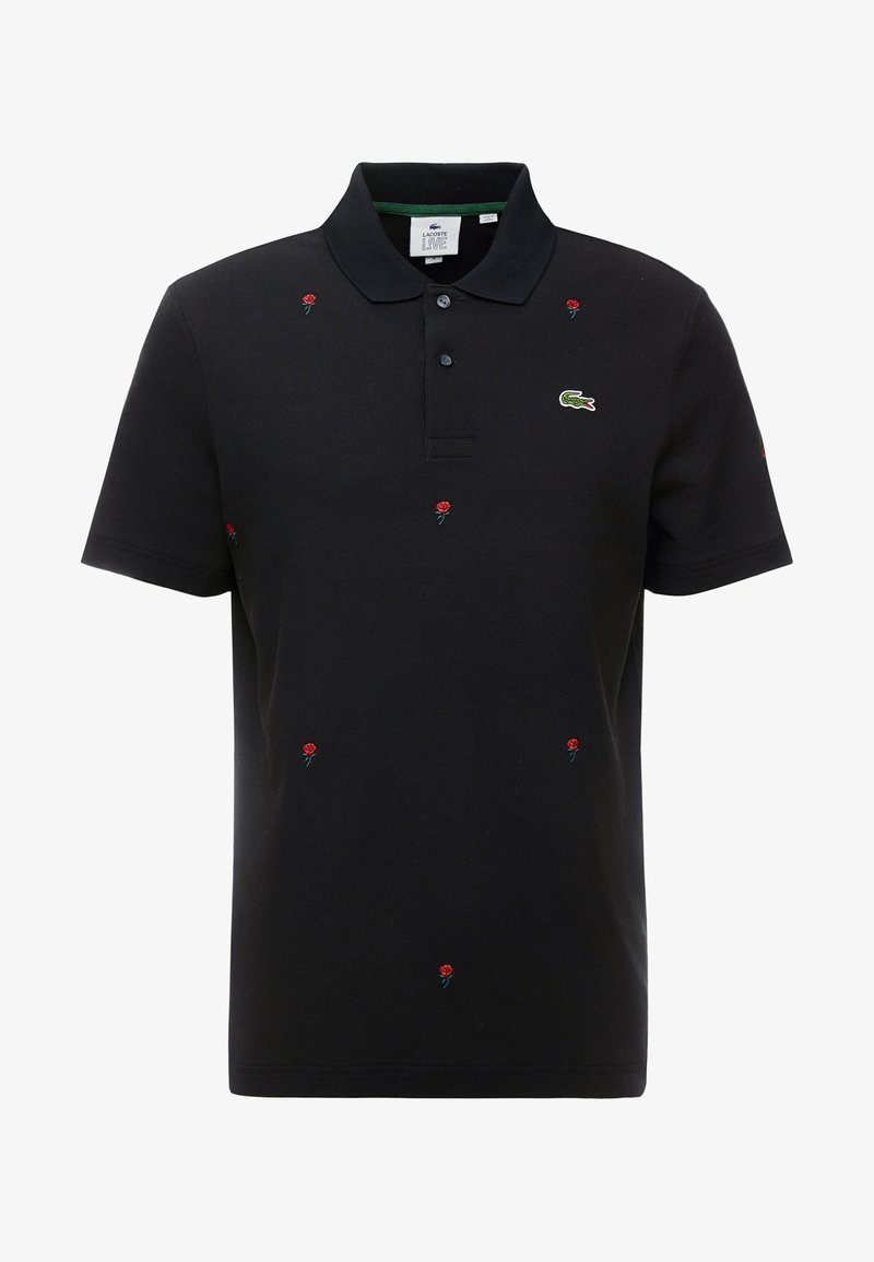 Polo shirt noir en coton, ornée de broderies de roses rouges sur l'ensemble et d'un logo vert sur la poitrine. Manches courtes et design de col.