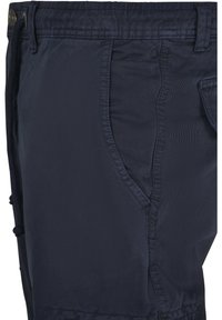 Navy blue shorts made of lightweight fabric, featuring side pockets, elastic waistband with drawstring, and a smooth texture.