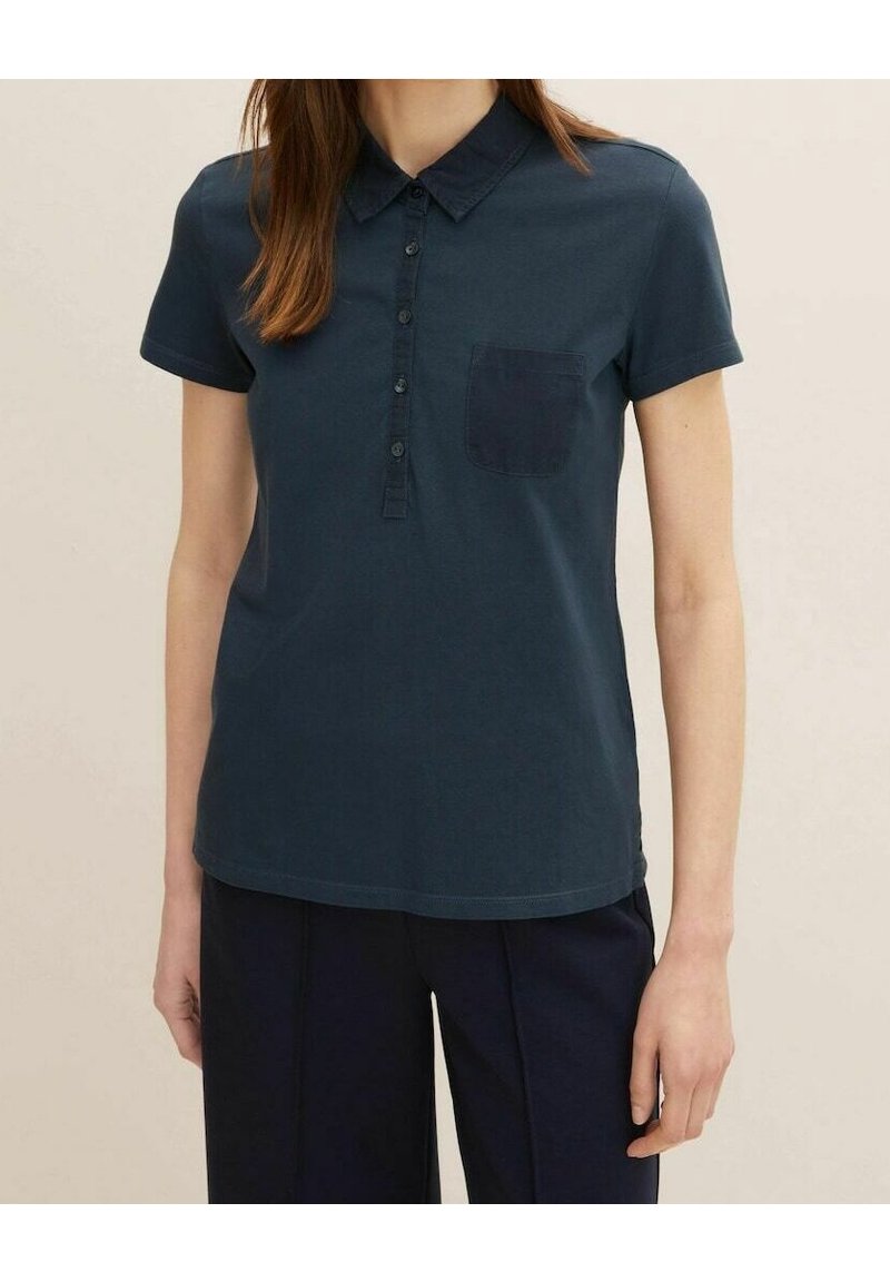 Navy blue cotton polo shirt with short sleeves, button-down collar, and a single chest pocket. Smooth texture and regular fit.