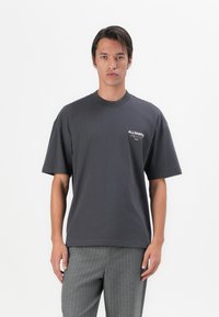 Dark gray cotton t-shirt with short sleeves, a crew neckline, and a small logo printed on the left chest. Simple design and standard fit.