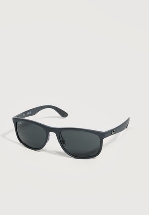 Schwarze Ray-Ban rechteckige Sonnenbrille mit dunklen Gläsern und dünnen Bügeln, die auf einer weißen Oberfläche liegen.
