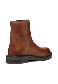 Brown leather ankle boot with a smooth finish, upright silhouette, contrasting stitching, and a flat rubber sole for stability.