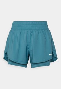 Pantaloni sportivi teal con vita elastica, design a strati, fessure laterali e un accento bianco del logo. Tessuto morbido e leggero.