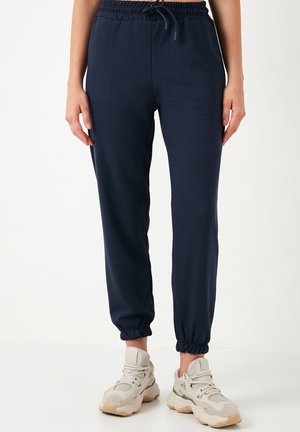 REGULAR FIT. - Tracksuit bottoms - dark blue