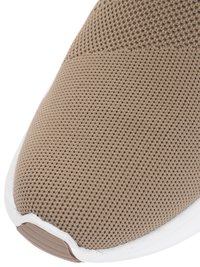 Beige knitted fabric sneaker toe with white sole and textured brown rubber tip.