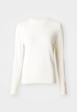 White long-sleeve knit sweater with a round neckline, ribbed cuffs featuring three gold buttons, and a soft texture.