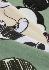 Four fabric swatches in varying colors: green, beige, black and white. The fabrics feature cartoon character patterns and textures.