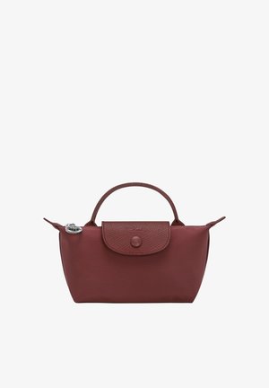 Small burgundy handbag with a textured flap, single top handle, and silver zipper pull charm on a white background.