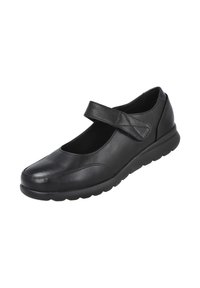 Zapato negro de charol estilo Mary Jane con tira de Velcro y suela de goma acolchada diseñada para la comodidad y un fácil ajuste.