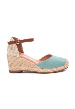 Zapato de cuña de ante verde con base de cuerda trenzada, correa en el tobillo con hebilla y tela a cuadros en la parte trasera. Diseño de punta redondeada.