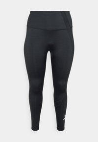 Svarta leggings med hög midja, tillverkade av ett slätt material. Har en texturerad sidopanel och en liten vit logotyp nära vristen.