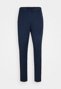 Pantalon de jogging athlétique bleu marine avec taille à cordon et logo Under Armour sur la partie supérieure de la cuisse gauche.