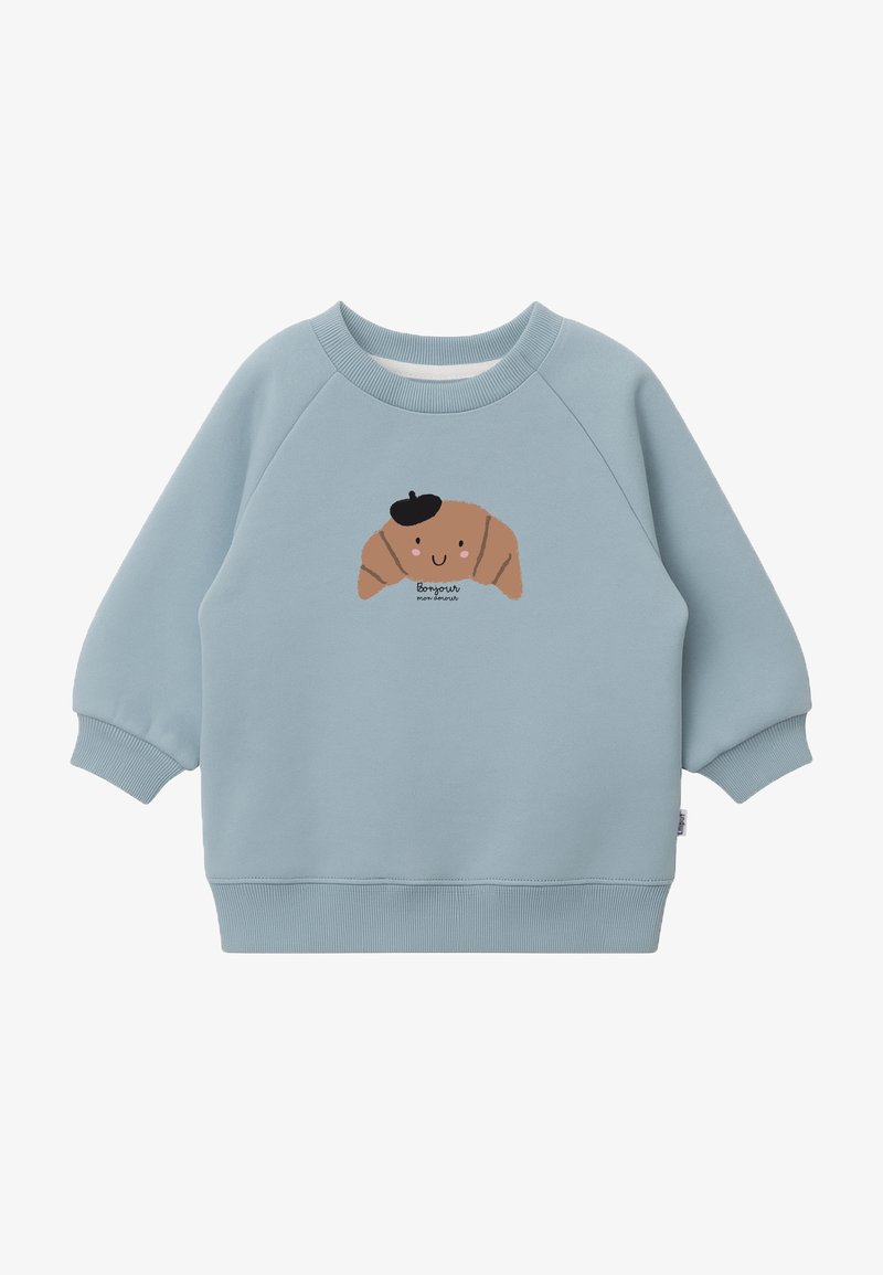 Hellblaues Sweatshirt mit gerippten Bündchen und Saum. Zentrale Cartoon-Design eines Croissants, das eine schwarze Baskenmütze trägt, mit dem Text "Bonjour" darunter.