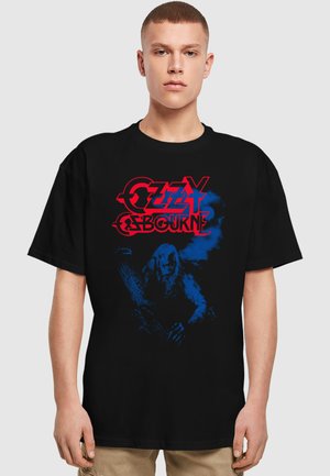 Black cotton t-shirt featuring blue and red graphic print of "Ozzy Osbourne" text and an illustrated figure against a dark background.