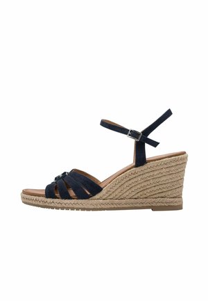 Marineblå ruskind kil-sandaler med krydsede stropper og en ankelrem med spænde. Kilhælen er syet med reb og har en glat brun indersål.