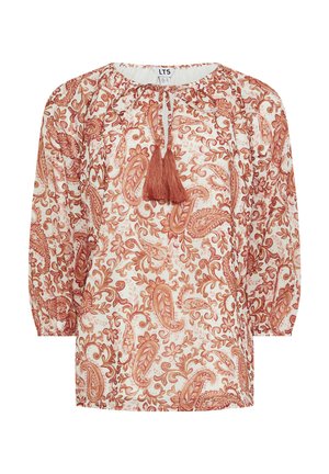 Boho-tyylinen paita, jossa on pitkät pallohihat, ruosteenvärinen paisley- ja kukkakuvio valkoisella pohjalla, tupsunauhakoristeiset nyörit pääntiessä.