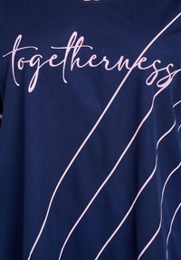 Navy blue t-shirt with a v-neck design featuring "togetherness" in cursive pink text and curved white lines across the fabric.