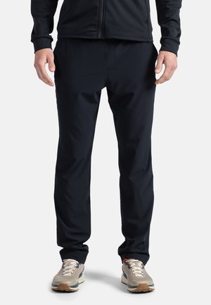 Black athletic pants with a slim fit, made from a smooth, lightweight fabric. Features an elastic waistband and minimal seams for comfort.