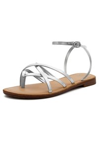 Sandali metallici argento con molteplici cinturini incrociati, suola piatta e cinturino alla caviglia. Sottopiede in pelle marrone con bordi cuciti.