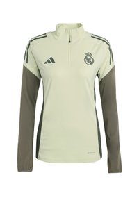 Light green athletic pullover with a high collar, zip neckline, long sleeves, and dark green accents. Features Adidas logo and Real Madrid emblem.