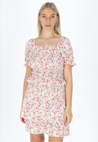 Blumenprintkleid mit kurzen Puffärmeln und einem gerafften Oberteil. Verfügt über voluminöse Akzente an der Taille und dem Rock. In den Farben Pink, Grün und Lila.