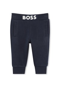 Pantaloni della tuta blu navy con texture a coste, dotati di tasche frontali e una vita elasticizzata bianca con il logo "BOSS" in evidenza.