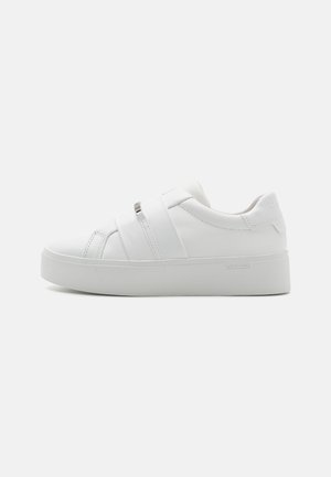 White low-top sneaker with thick sole, two wide straps across top, and subtle Calvin Klein logo on side and heel tab.