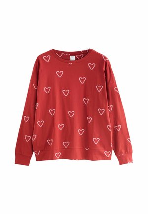 Pulover roșu cu modele de inimi albe, mâneci lungi, decolteu rotund și o croială lejeră. Fabricat dintr-un material moale din bumbac.