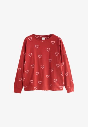 Red sweatshirt with white heart patterns, long sleeves, round neckline, and a relaxed fit. Made of soft cotton material.