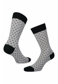 Szare skarpetki z geometrycznym granatowym wzorem, czarną, prążkowaną mankietą oraz czarnymi akcentami na piętach i palcach. Wykonane z lekkiego materiału bawełnianego.