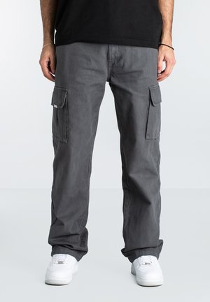 Gray cargo pants with multiple side pockets, a straight-leg design, and a casual fit, paired with white sneakers. Cotton material.