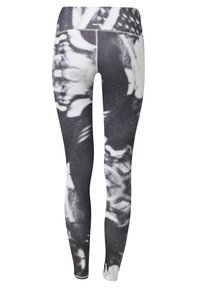 Legginsy w czarno-białe wzory wykonane z elastycznego materiału. Posiadają wysoki stan oraz abstrakcyjne wzory o teksturowanym wyglądzie.