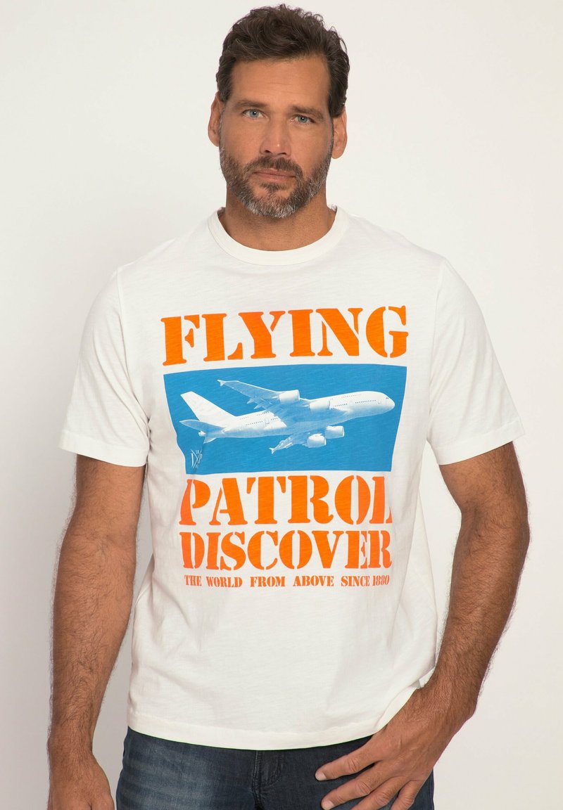 White cotton t-shirt featuring bold orange and blue graphic text: "FLYING PATROL DISCOVER" with an aircraft illustration. Round neckline, short sleeves.