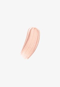 Shimmering, creamy highlighter swatch in soft peach color with a smooth texture and subtle sheen, applied in a curved shape.