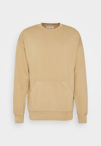 Beige sweater gemaakt van een katoenmix, met een ronde halslijn, lange mouwen en een voorzak in kangoeroestijl. Eenvoudige stiksels, geen patronen.