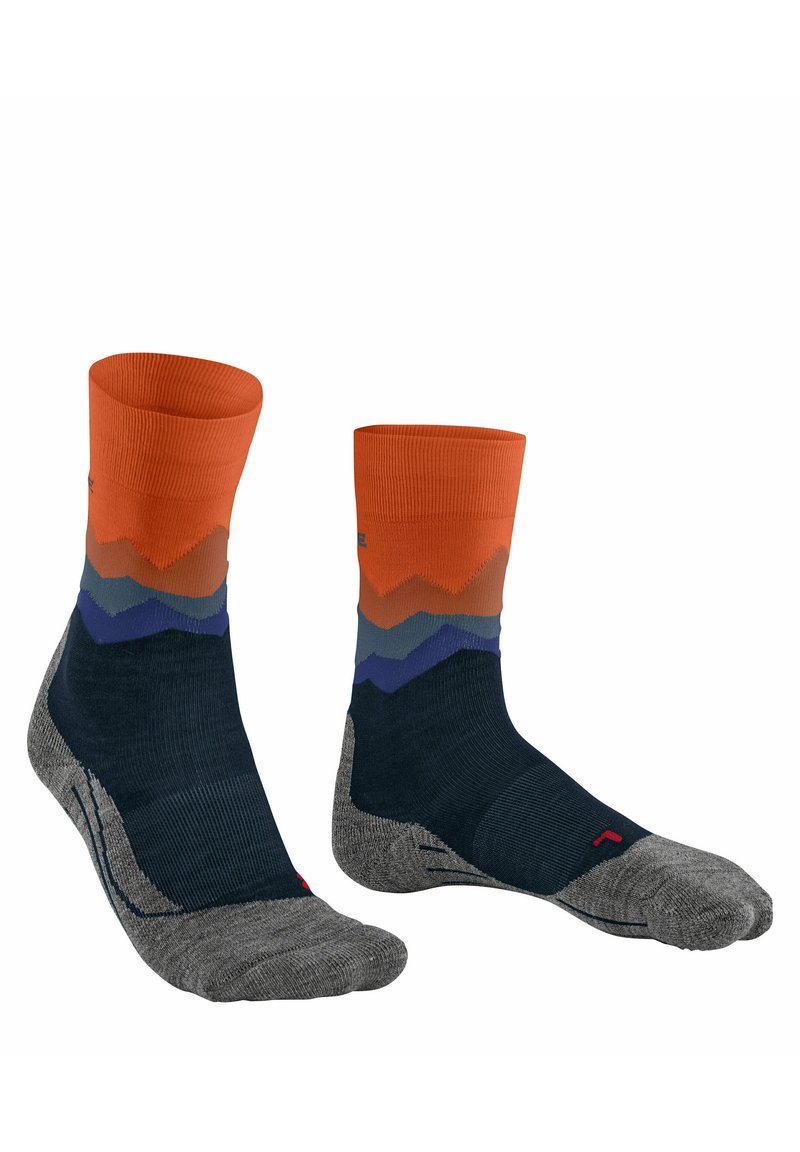 Calcetines hasta el tobillo con un patrón de zigzag en naranja, azul y gris, hechos de una mezcla de materiales texturizados y lisos. Las suelas grises añaden contraste.